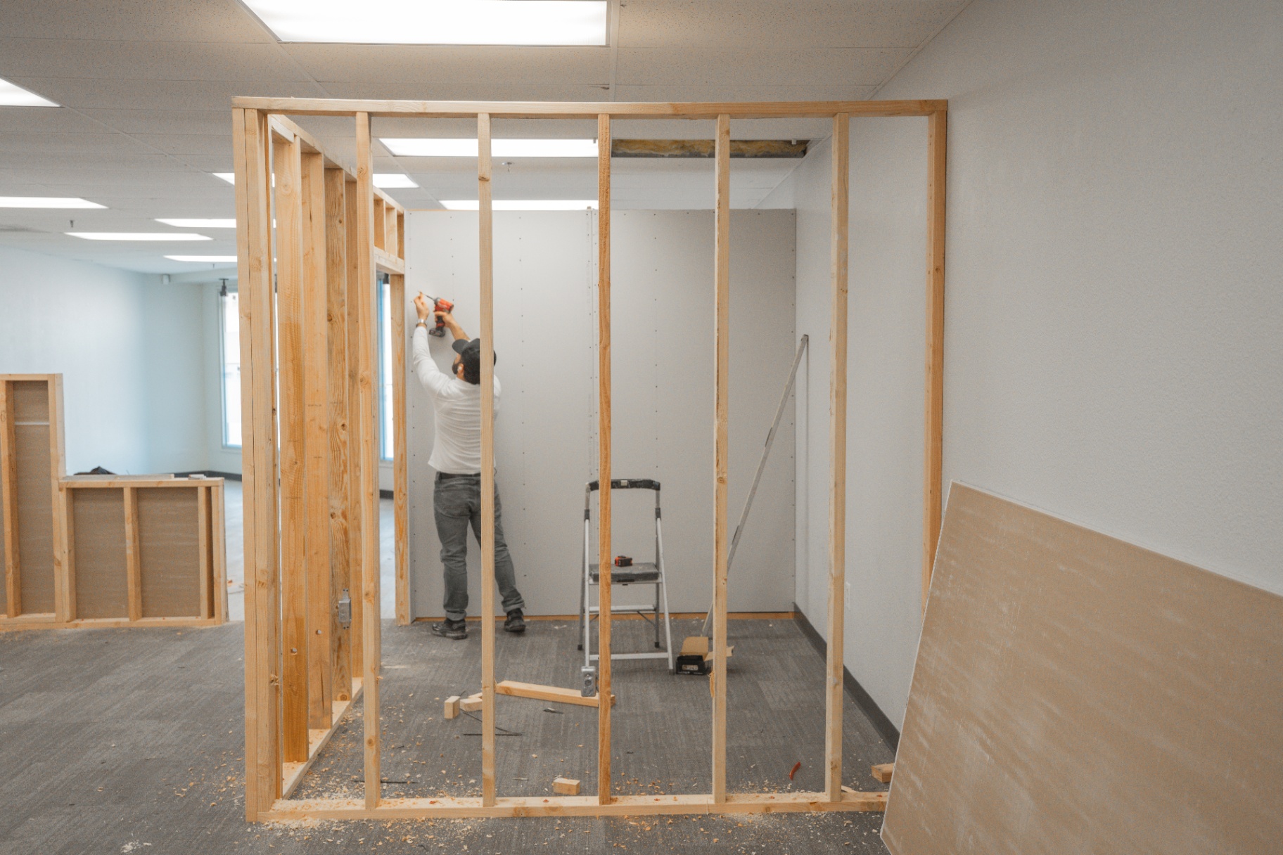 Carpenter framing interior partition wall in commercial buildout
