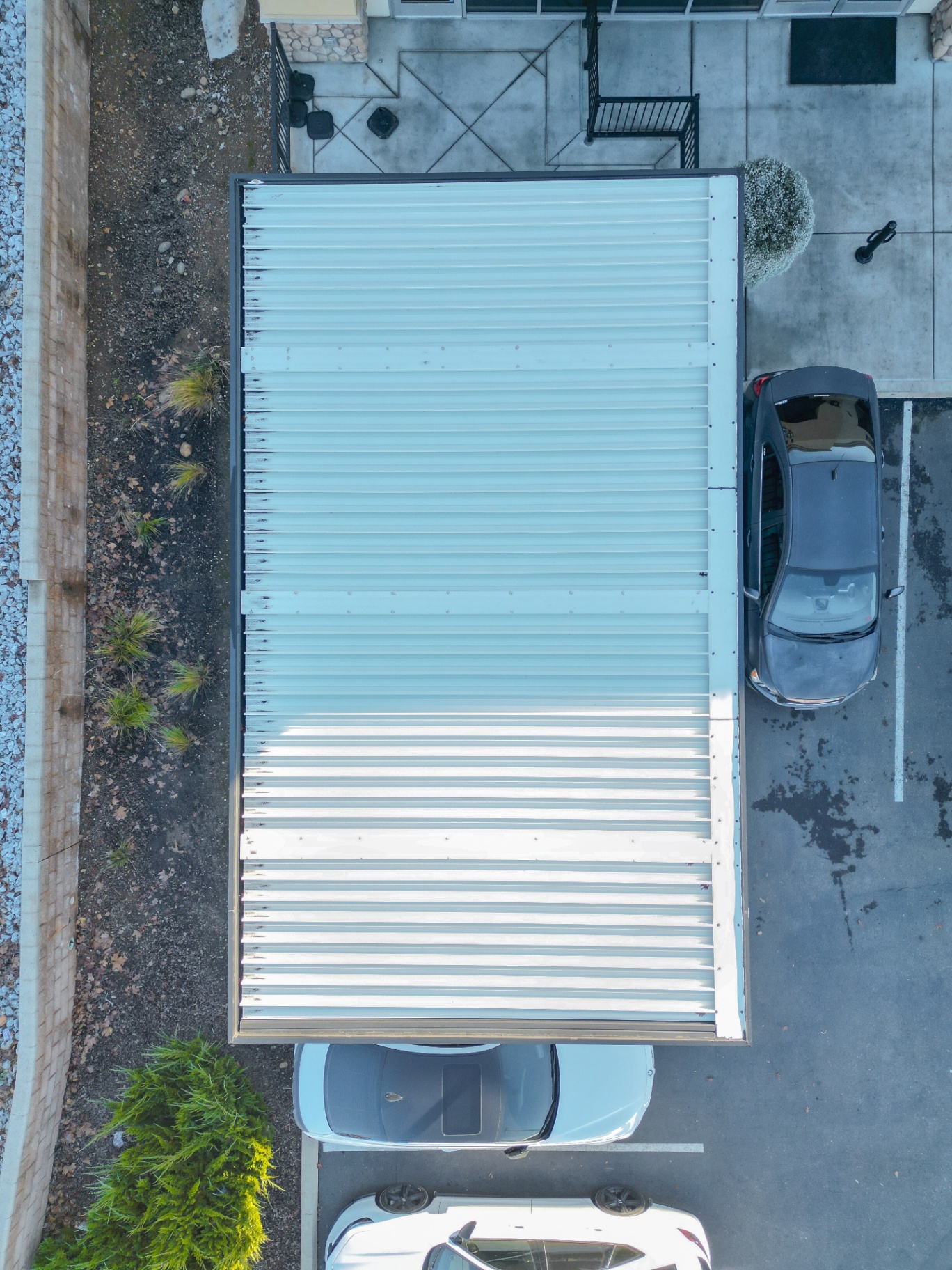 Top-down drone view of metal patio cover installation