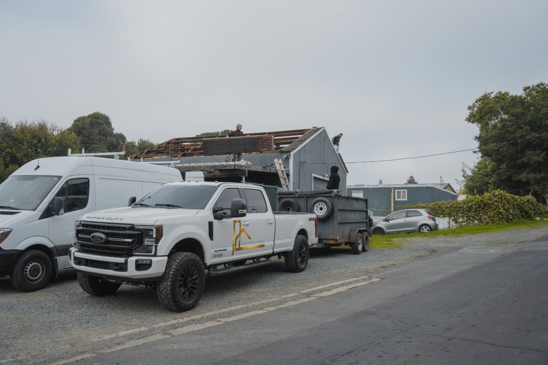 Work truck with dump trailer at the active roof demo site