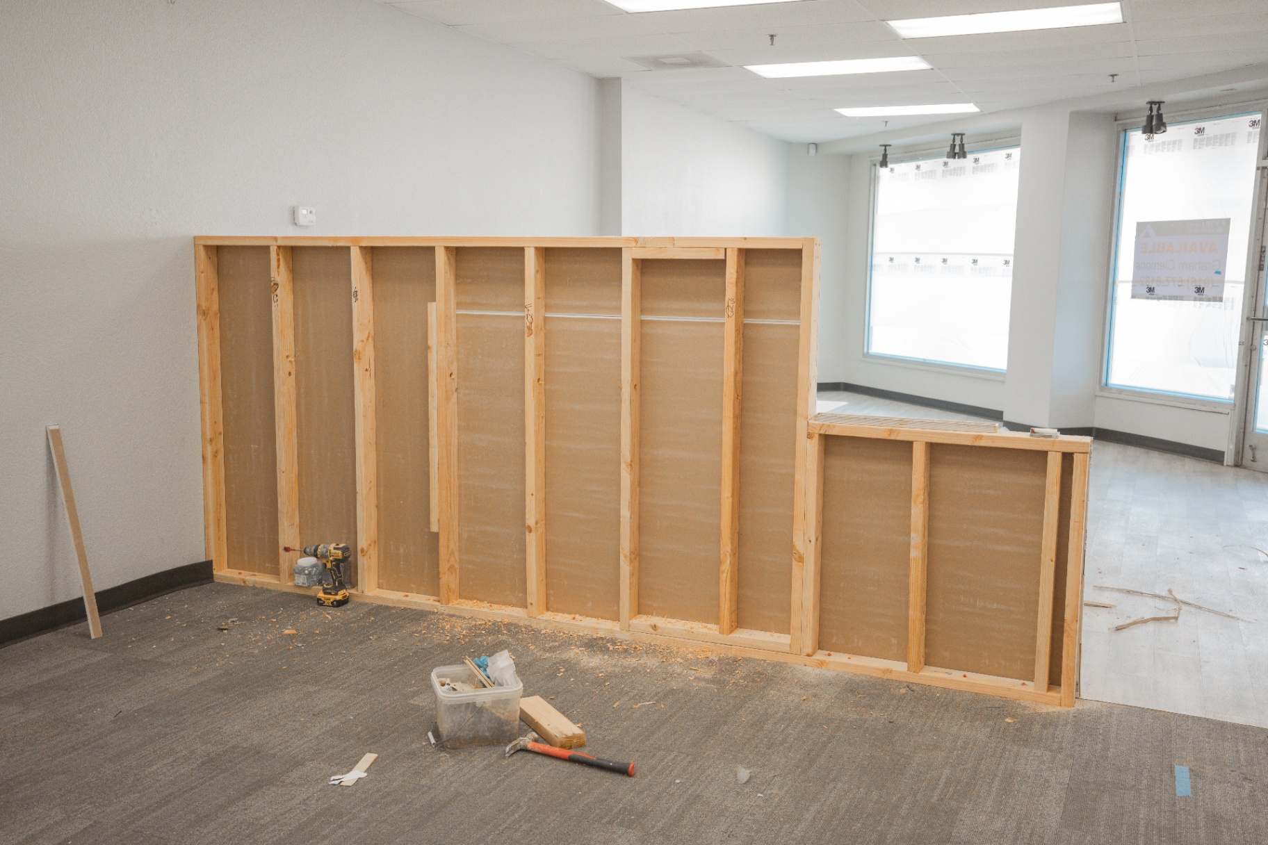 Framed partition wall and reception counter during commercial buildout