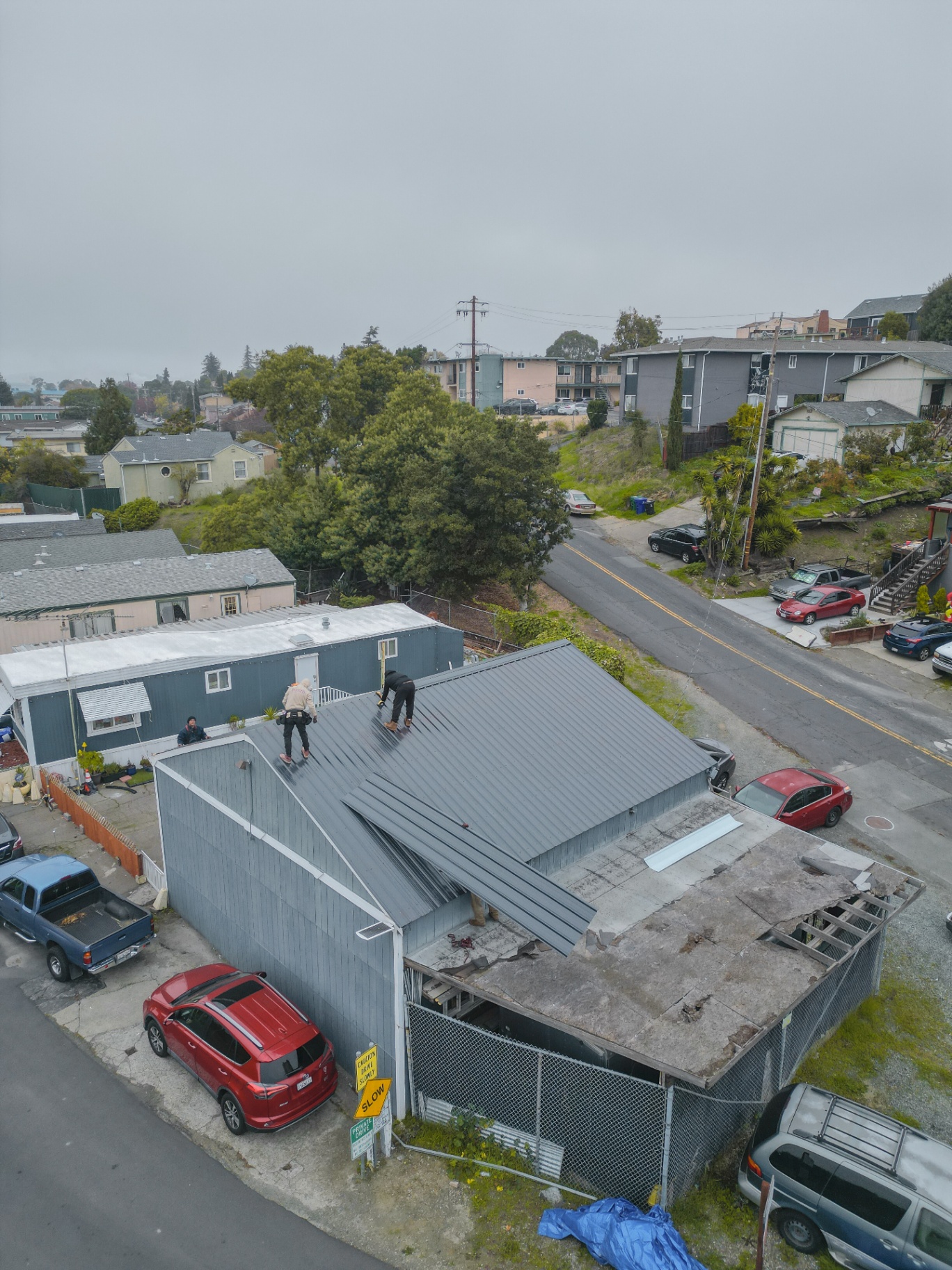 Drone view of finished metal roof on residential property