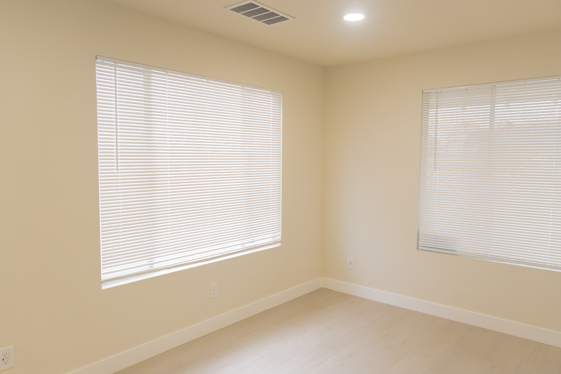 Finished bedroom or office space with new flooring and dual windows