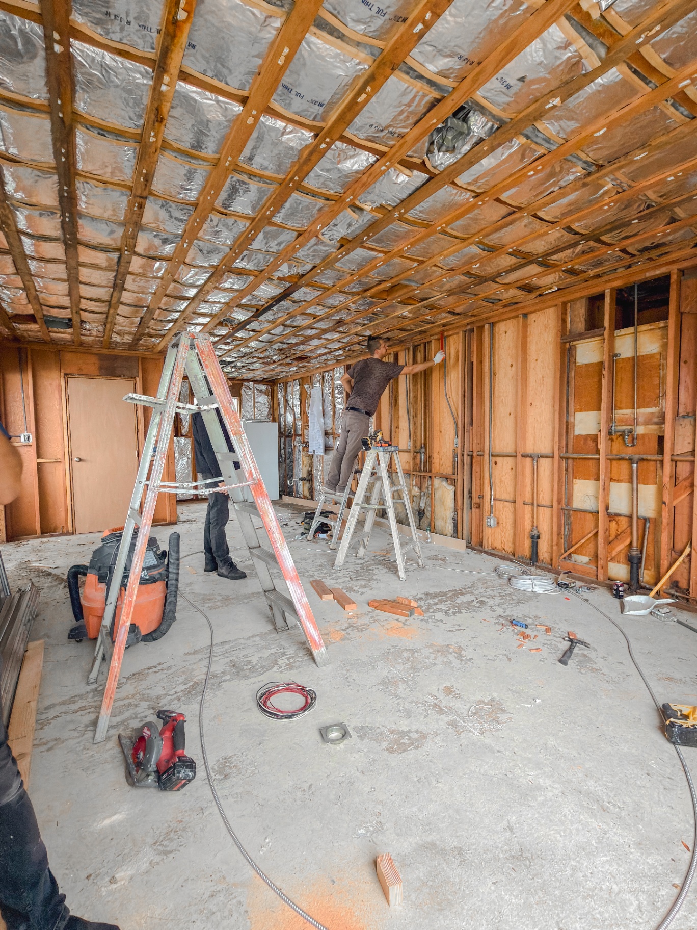 Interior framing and electrical rough-in work during renovation