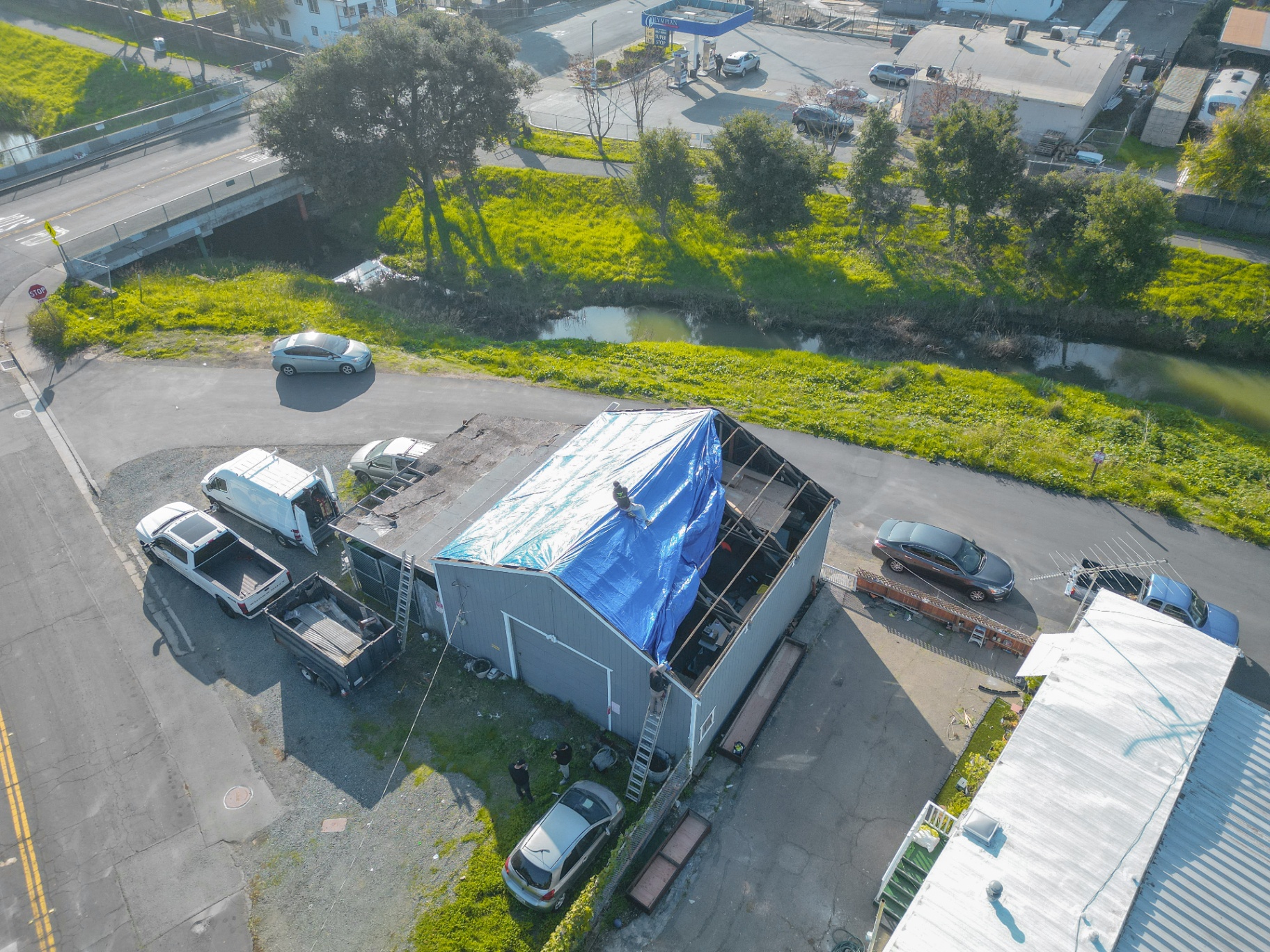 Aerial overview of tarped roof and job site