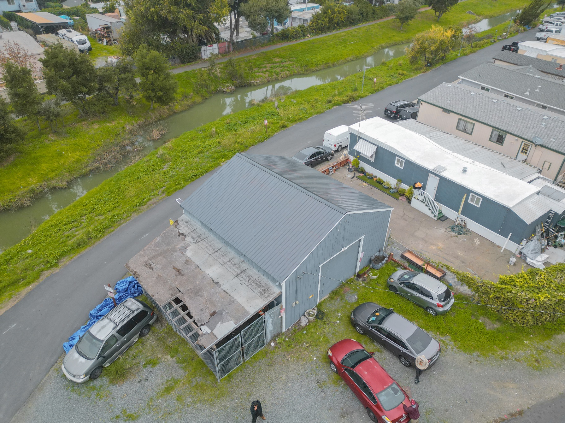 Aerial view of damaged shed roof needing repair