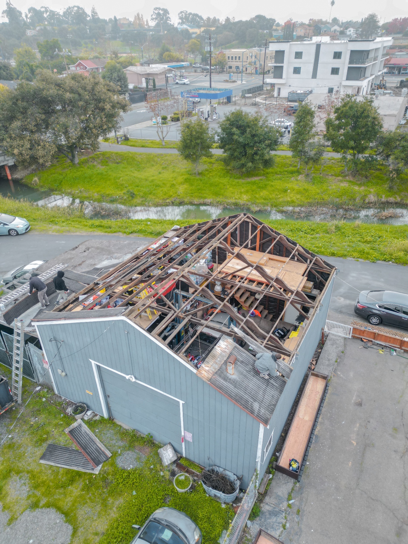 High aerial view of the shed roof fully opened during demolition