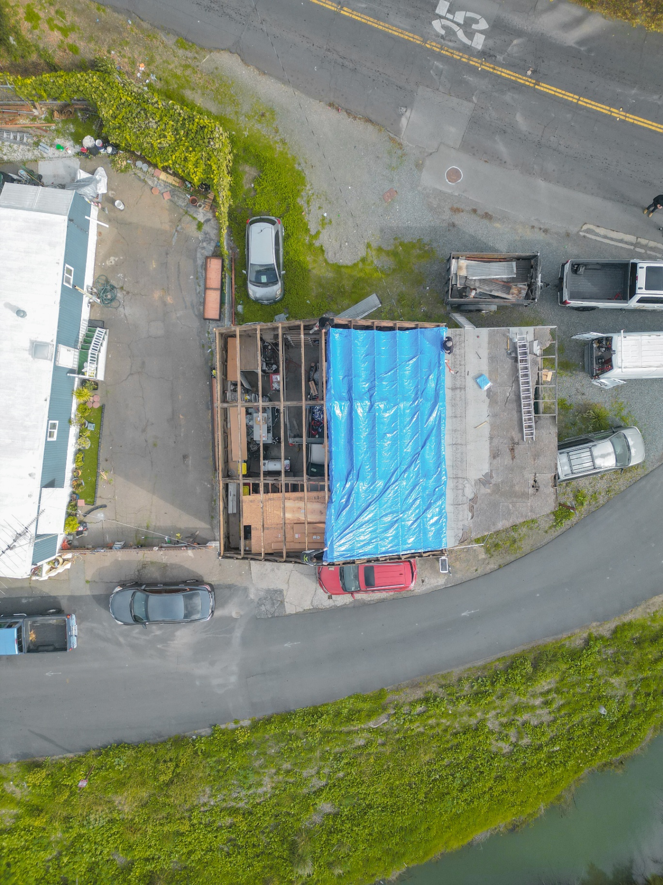 Top-down aerial of tarped roof project